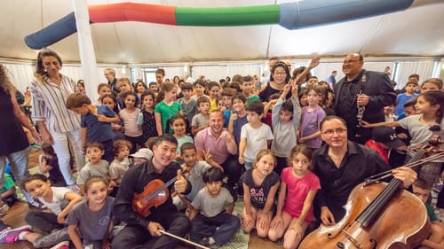 A quartet of orchestra musicians, Nézet-Séguin and other members of the tour visit Oasis of Peace, an Israeli community that was jointly established by Jewish and Arab Israeli citizens. (Photo by Jan Regan.)