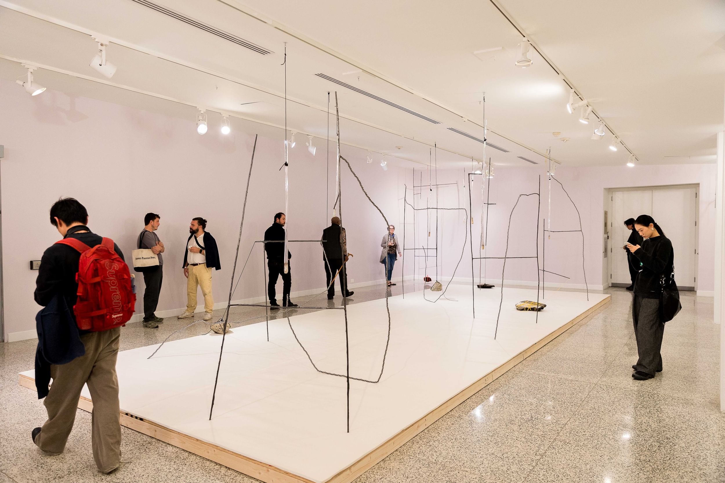 Eight people move around a tense yet roomy artwork of thick wires and suspended chunks of concrete.