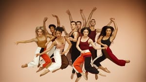 Eight dancers in various poses in mid air look on towards the camera