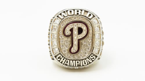 Large oblong-shaped ring covered with small diamonds has the Phillies logo at center; “world” above & “champions” below