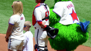 An appreciative crowd stands at the Phillies game. (Photo by SLGCKGC via Creative Commons/Flickr)