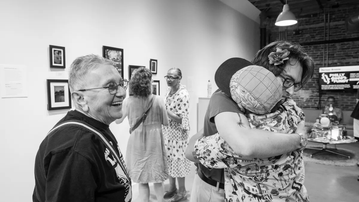 Philadelphia artist and activist Arleen Olshan with attendees at the opening of This Is (Not) a Celebration at Huddle in Northern Liberties