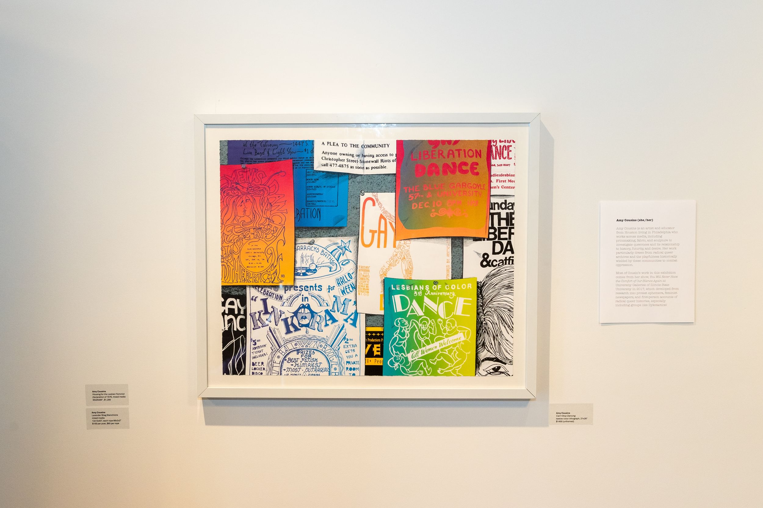 On a white wall, a large white picture frame full of colorful 1970s flyers advertising queer activist parties and fundraisers