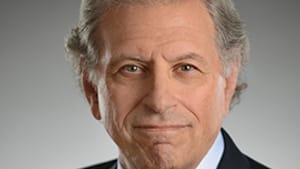 A classic headshot photo of Swartz. He wears a black suit jacket with a tie and shirt