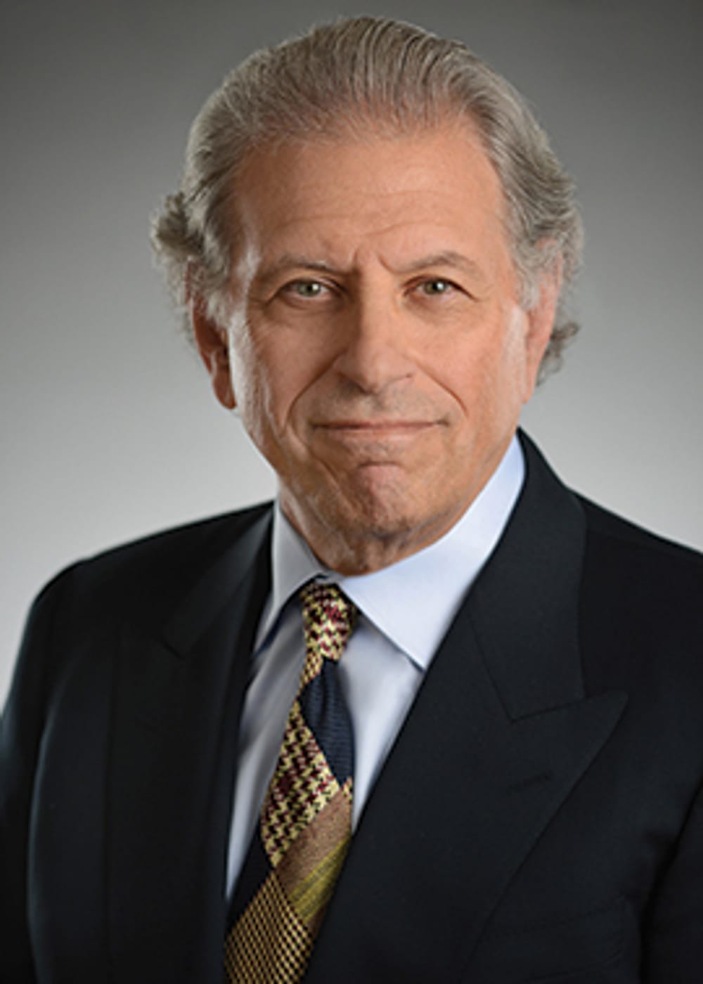 A classic headshot photo of Swartz. He wears a black suit jacket with a tie and shirt