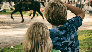Last year's festival-goers watch the march. (Photo courtesy of Historic Germantown.)