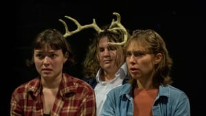 Against a black background, the actors sit together as if crowded in a car, with Presley in the back, wearing deer antlers.