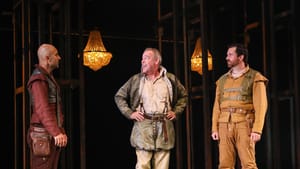 Peakes and Close face Ebrahimzadeh, at left. Peakes smiles and Close looks anxious. They’re in subdued Elizabethan costumes.