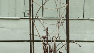 Graceful abstract 49-inch-high steel sculpture. Lines tipped by small balls arch in many directions from a rectangular frame