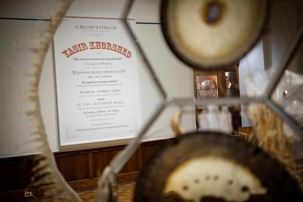 Seen through Maravilla’s multimedia sculpture, Ken Lum’s text art is mounted large on the gallery wall.