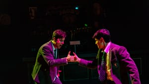 Dressed in prep school blazers and lit in dramatic purple and green, Corey and Tyler thumb wrestle excitedly.