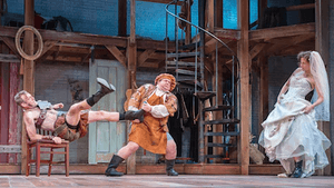L to r: Ian Merrill Peakes's Petruchio, assisted by his servant Curtis (Brendan Doyle), as Eleanor Handley's Katherina observes. (Photo by Lee A. Butz)