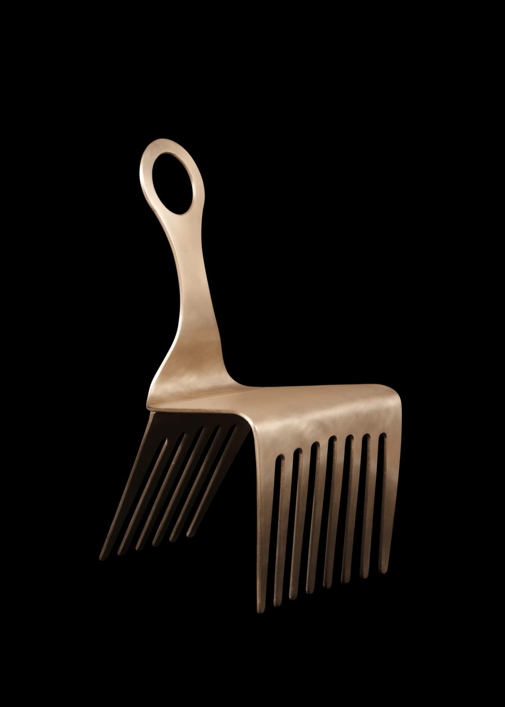 A stylish, simple bronze chair with front and back legs like an Afro pick, with the handle forming the chair’s back.