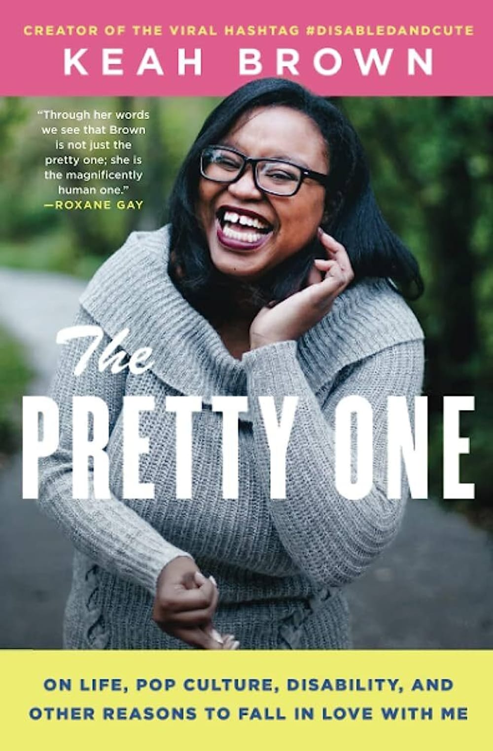 Book cover w/ The Pretty One prominent overlaying Brown, a Black woman, wearing a gray sweater, glasses, outdoors, smiling