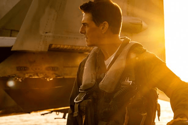 Film still. Actor Tom Cruise in Air Force gear, sun beaming right from the right side of the frame
