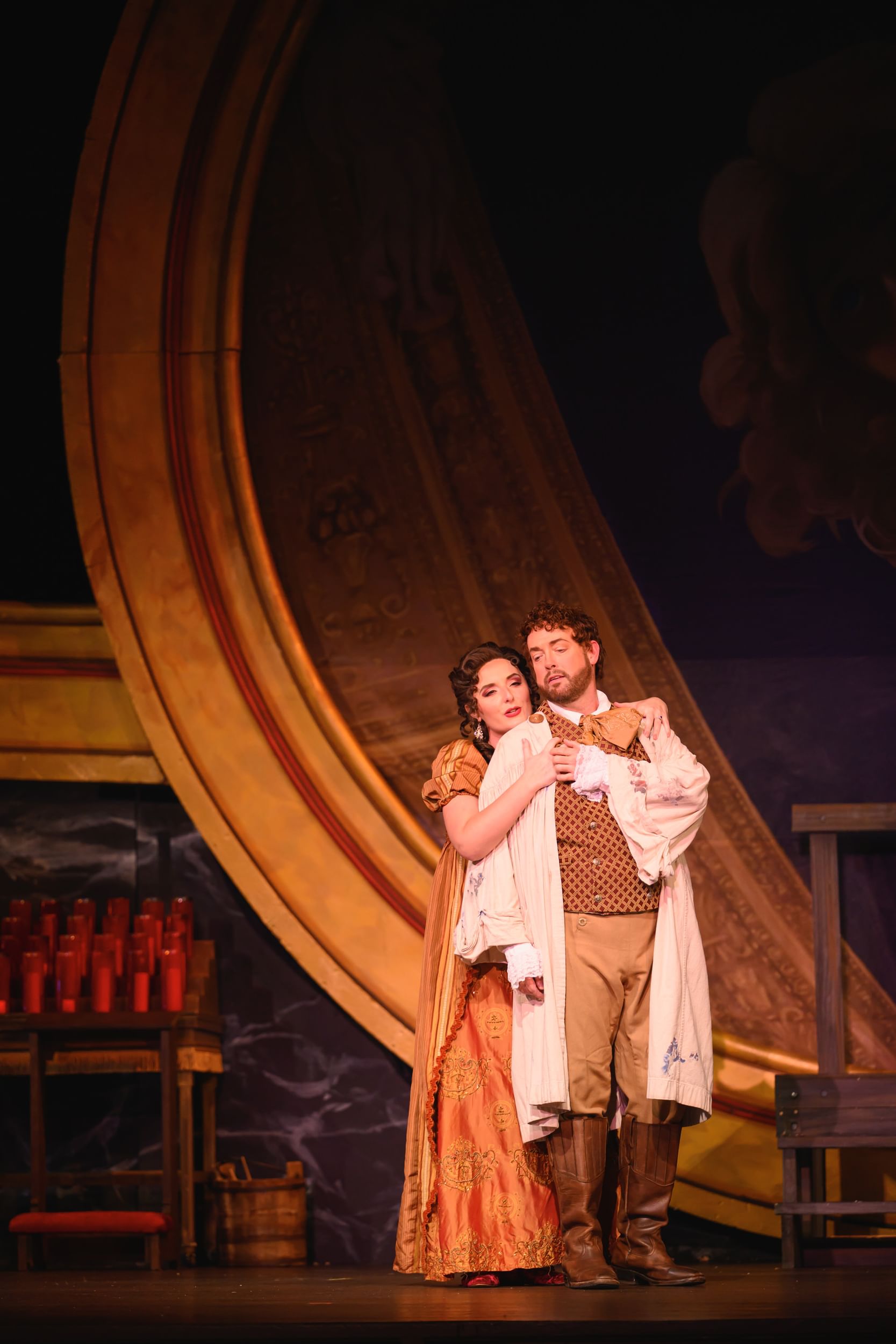 Closeup on the two actors, in lush period costumes, embracing in a wistful, romantic way.