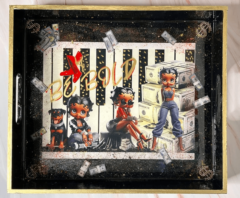 Mixed media art. Three different poses by Betty Boop over piano keys, stacks of money, and other artifacts.