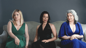 Jessica Beebe, Michele Kennedy, and Maren Montalbano sit together in formal gowns, posing for photo