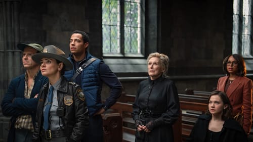 Six diverse actors stand with inquisitive, worried, or skeptical expressions in the wooden pews of an ornate church.