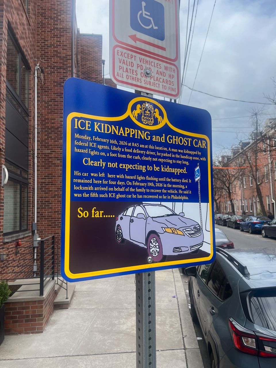Close-up on a faux blue PA state historic sign describing the kidnapping by ICE in yellow text, with an illustration of a car