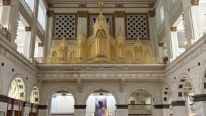 View from ground floor looking up at the grand architecture of the Court, giant gold organ one story above the marble floor