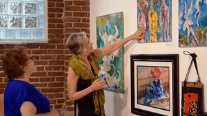 Artist Kathy Robinson (on right) discusses her work with Ruth Joray. Both live in Mt. Airy. (Photo by Mary Ann Domanska)