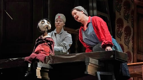 Not the most dynamic scene partner: Elza van den Heever’s (right) son is a puppet. (Photo by Ken Howard for the Met Opera.)