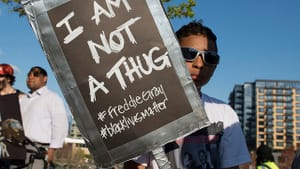 Participant in a Minneapolis rally to support the people of Baltimore. (Photo by Fibonacci Blue via Creative Commons/Flickr)