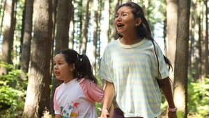 A still from 'Beans.' Two young Mohawk girls are in a wooded area, appearing to be yelling out of fear, concern