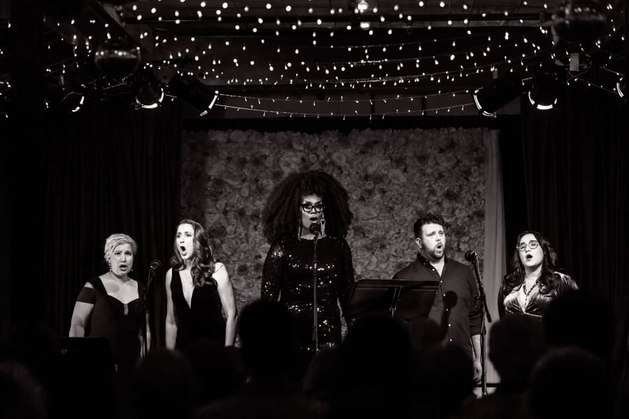 Black and white photo of a group of singers on stage
