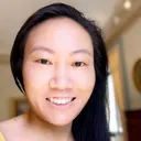 Krista Mar, an Asian American woman with medium-length black hair. She is smiling and wearing a yellow shirt.