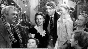 A still from 'It's a Wonderful Life.' A large family gathers together, in black and white.